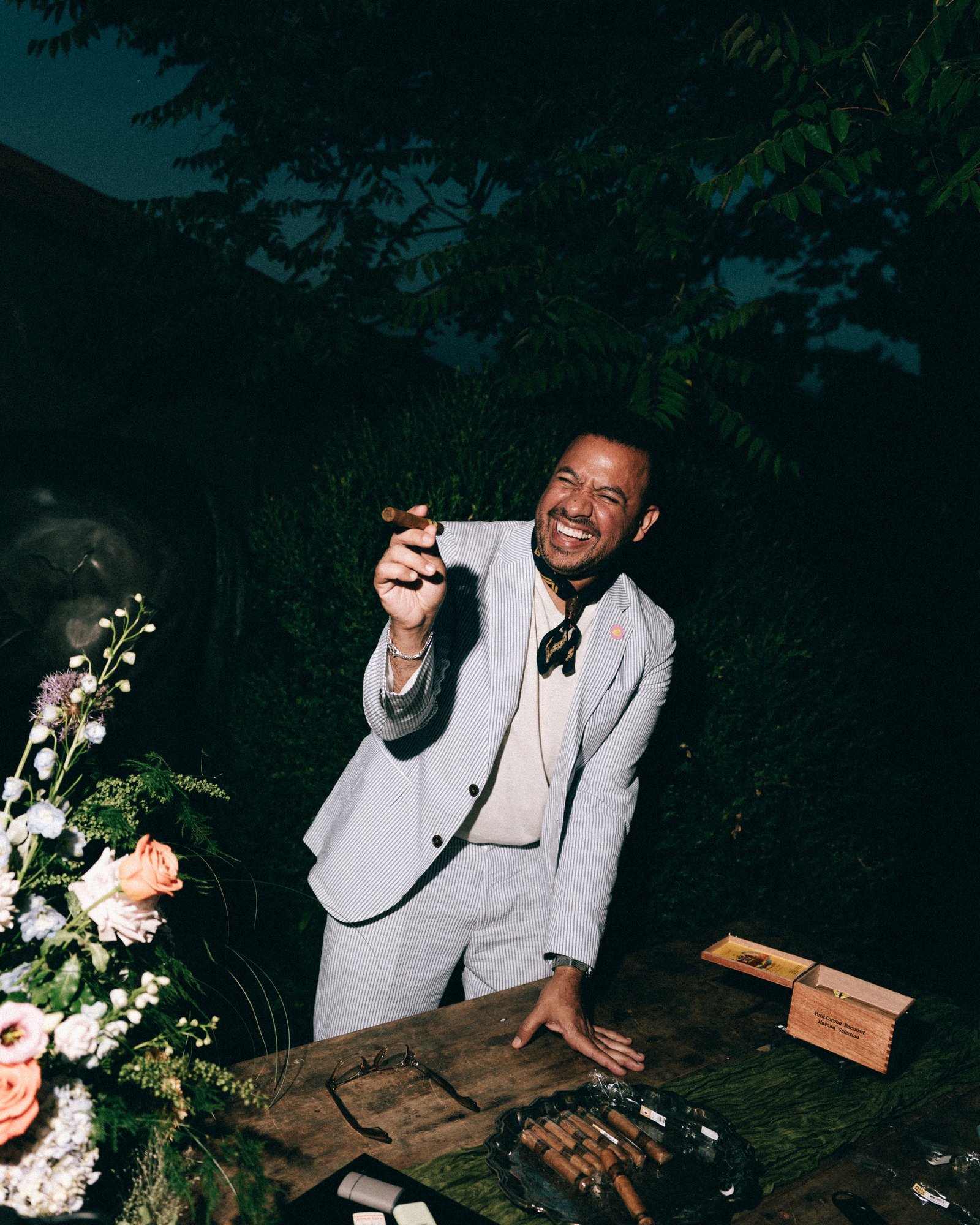 A guest in a white dinner jacket working the DJ table