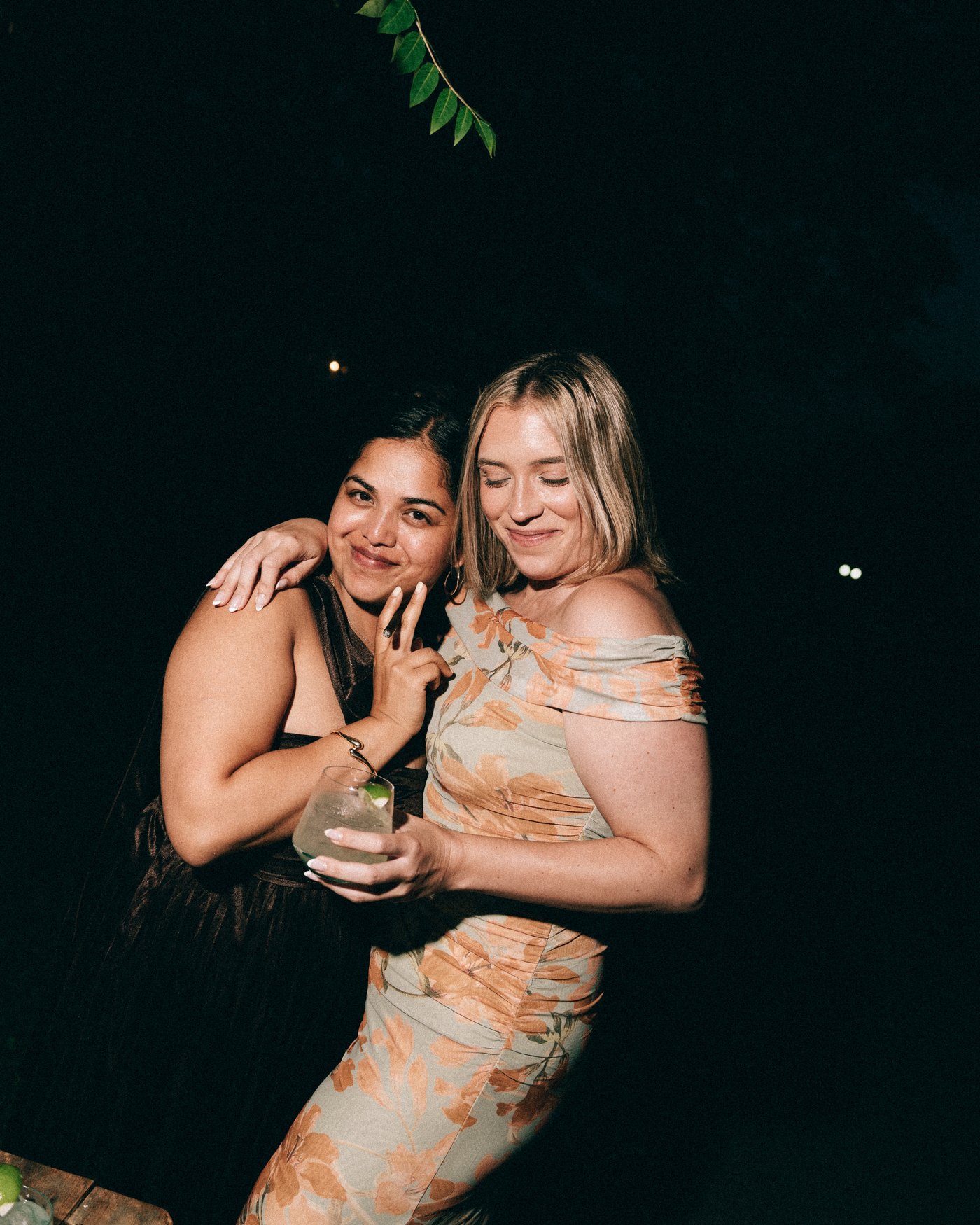 Two guests arm in arm at the end of the night
