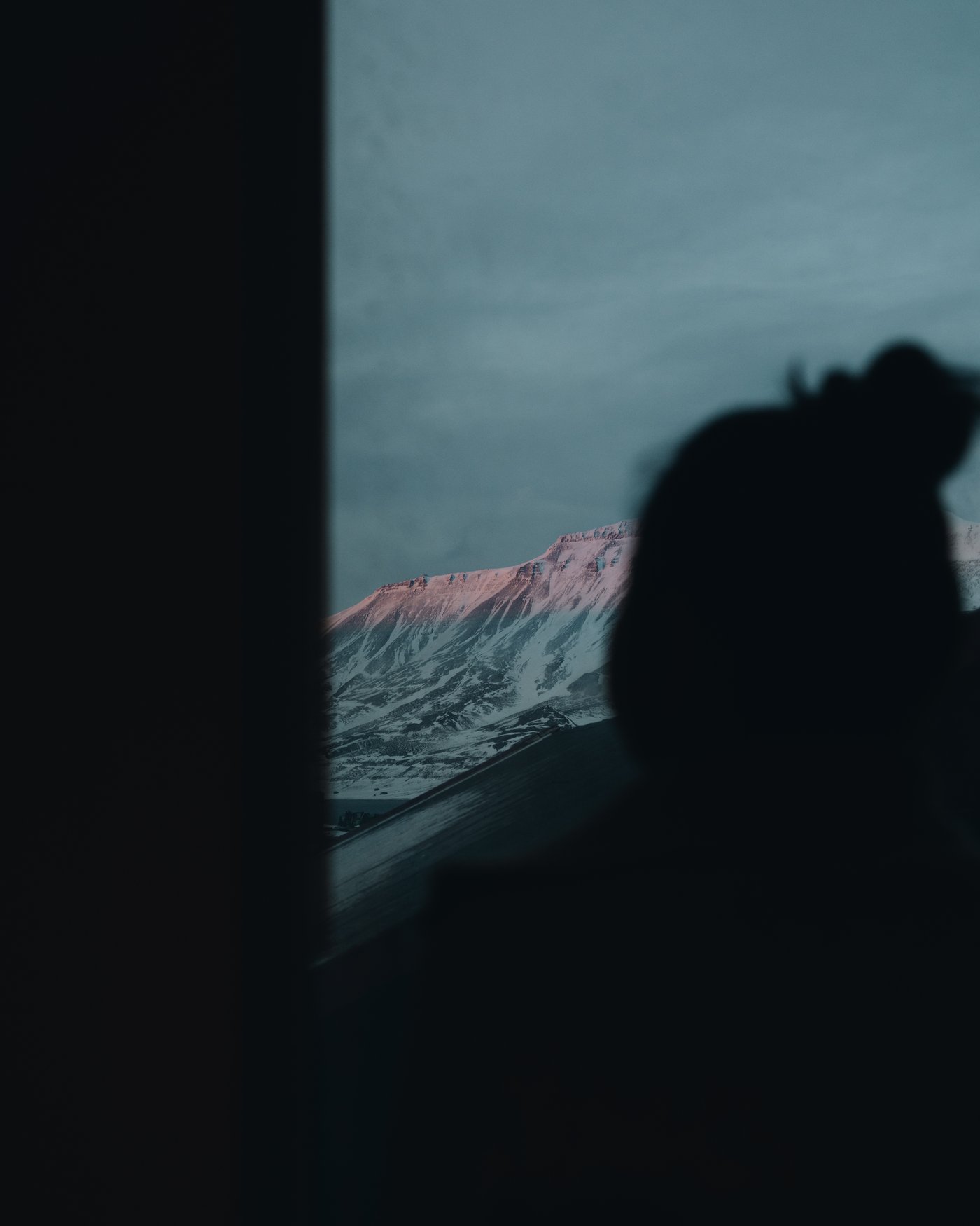 The same windows, last light coming off the mountain.
