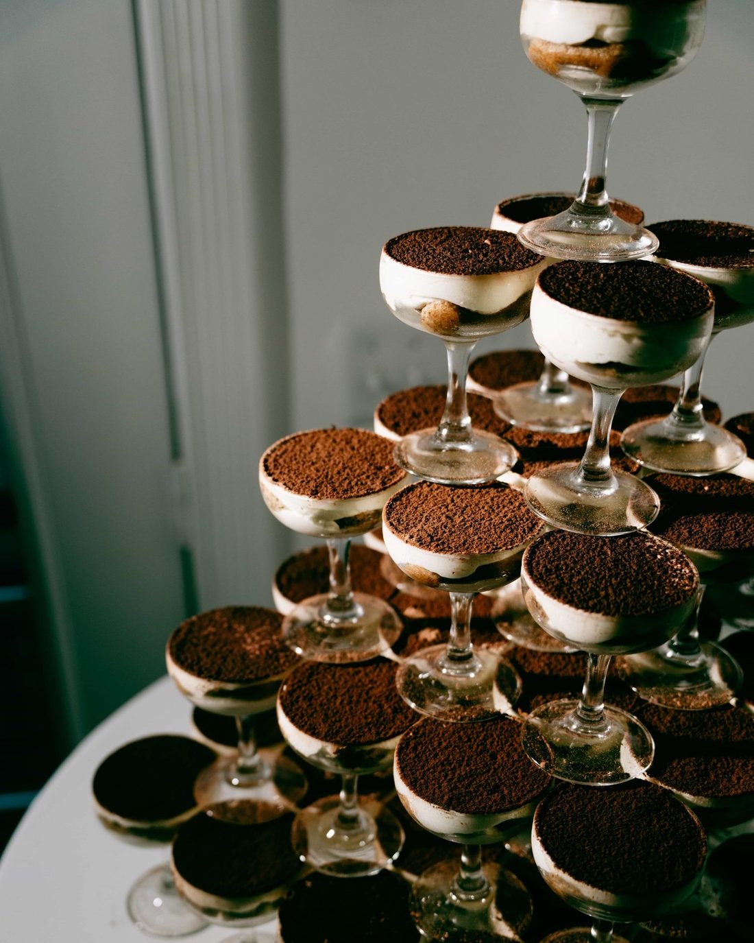 A tower of coupe glasses filled with espresso dusted dessert