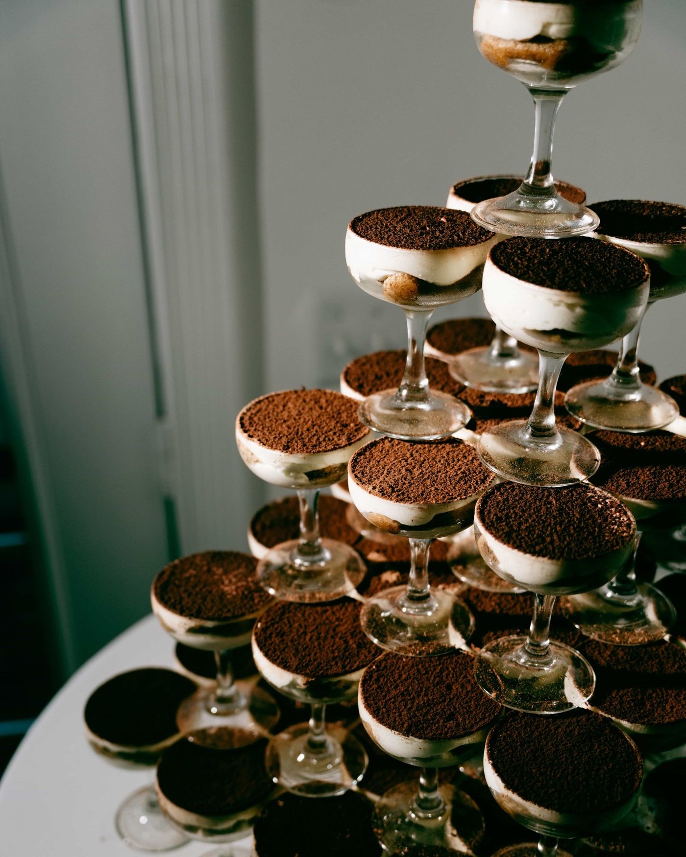 A tower of coupe glasses filled with espresso dusted dessert