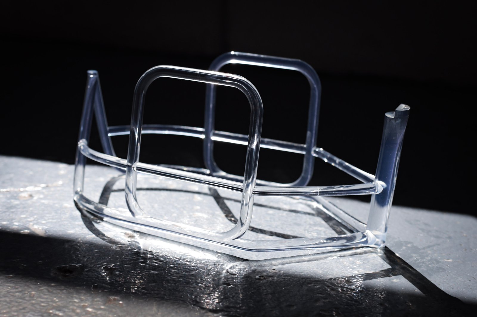 A polished optical clear frame, where the geometry has to read through every curve.