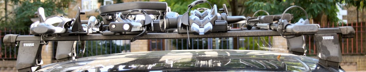 Four Thule bike racks mounted on an estate car roof rear view