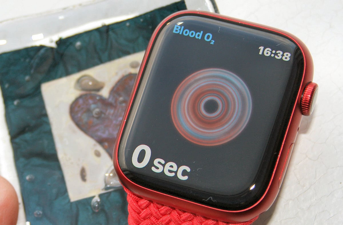 Apple Watch Series 7 on wrist showing health sensors, no blood glucose smartwatch capability exists