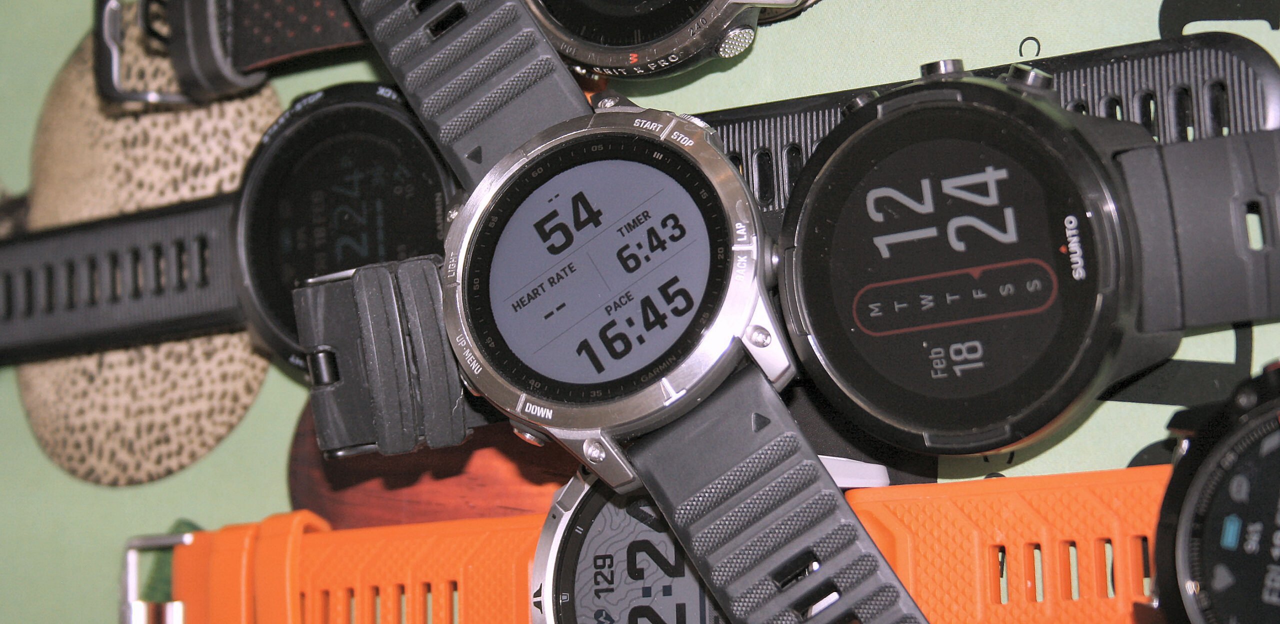 Garmin Fenix 7 vs Coros and Suunto watches showing the difference in style.