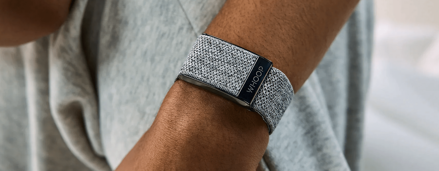 close up hi res image of whoop strap on a mans left wrist, showing band over sensor