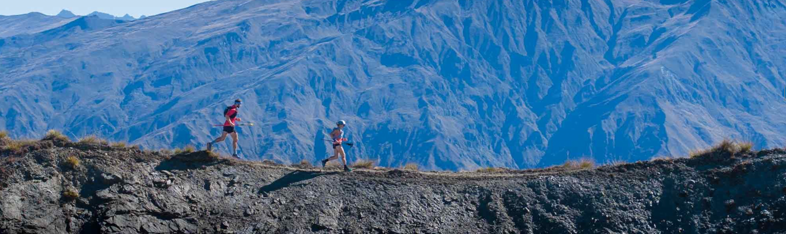 runners racing on a mountain ridge with garmin watches