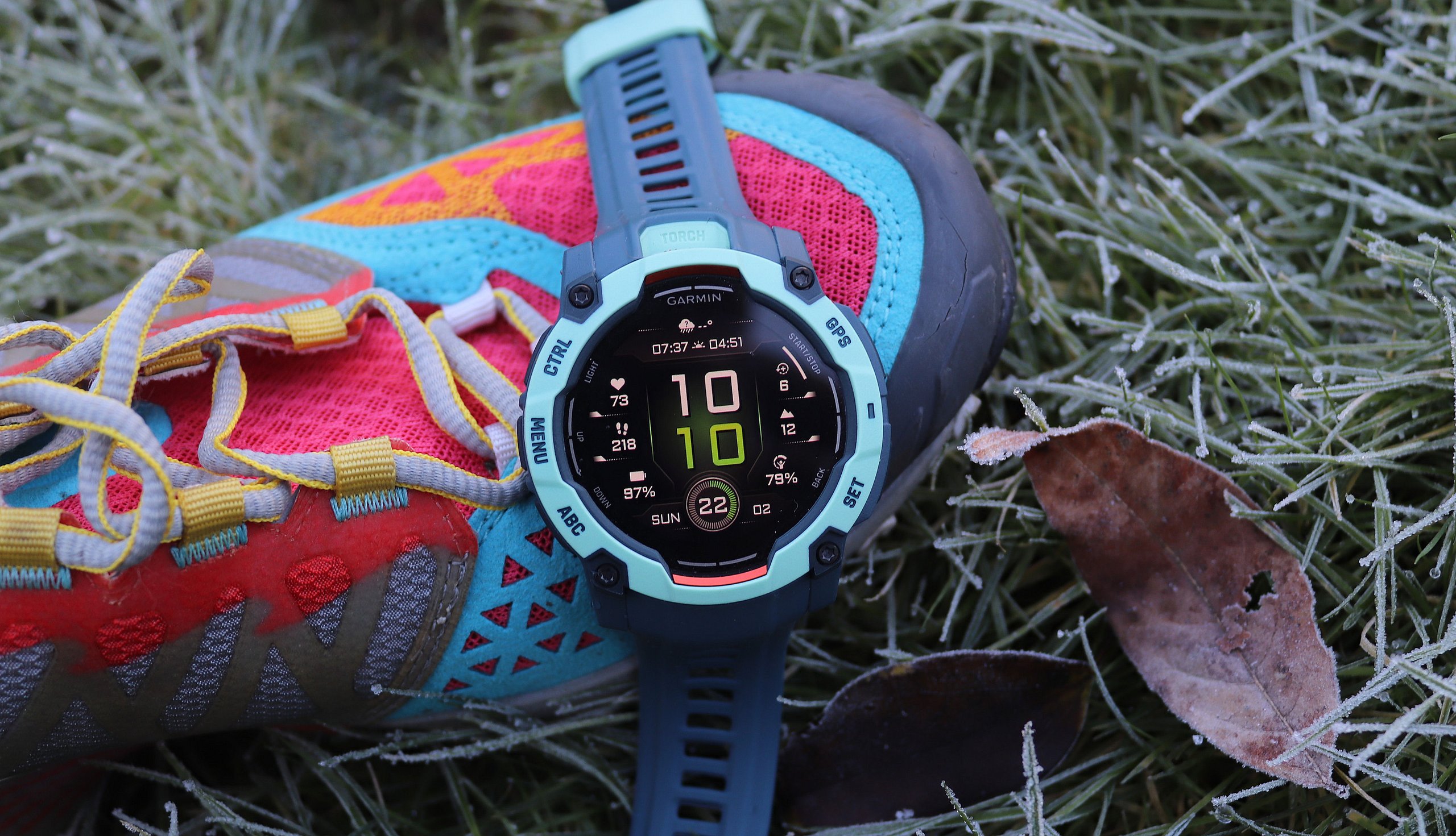Garmin Instinct 3 close up on a trail runner's shoe