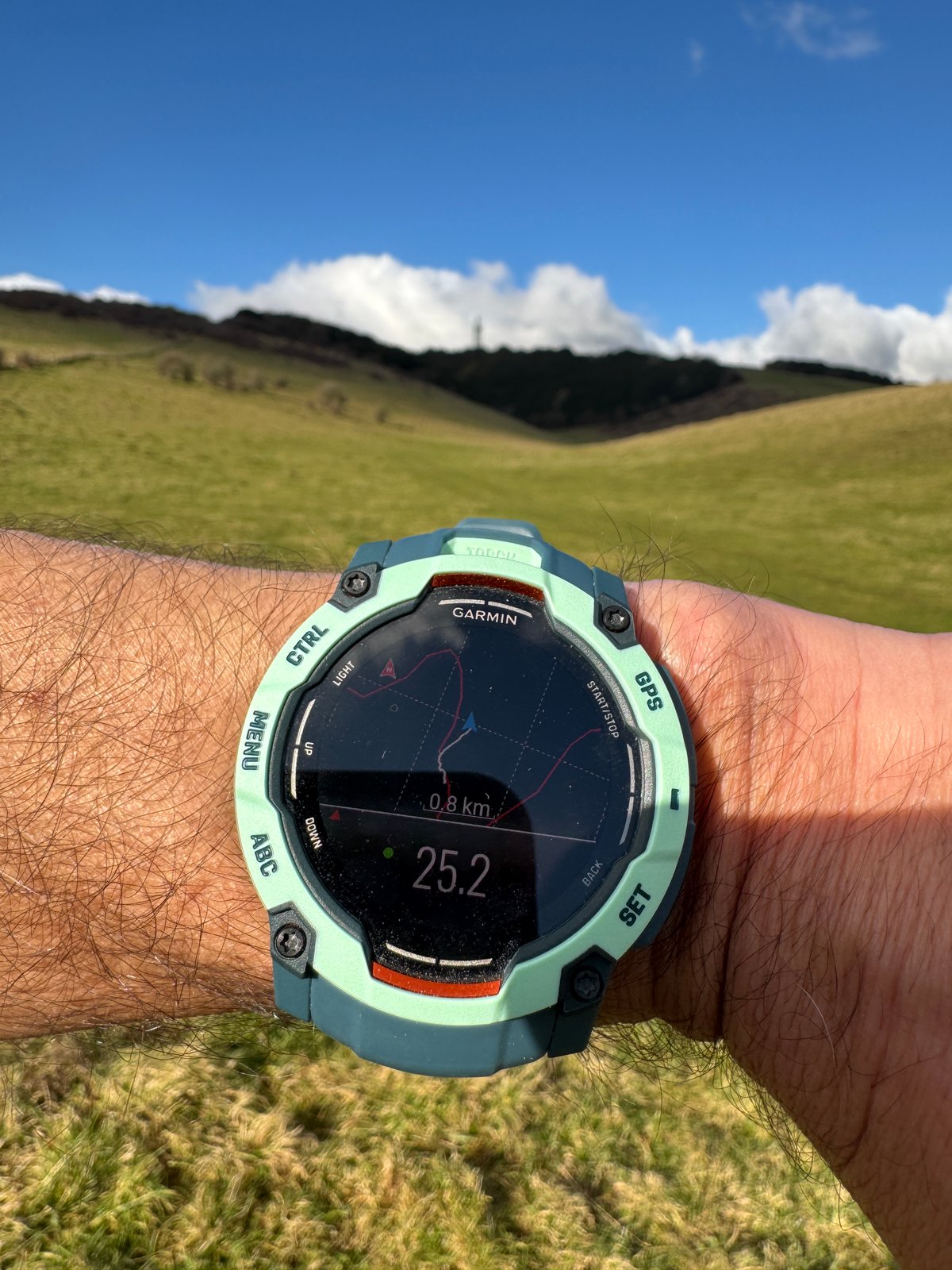 Close-up of Garmin Instinct 3 screen showing a clear off-track alert during navigation