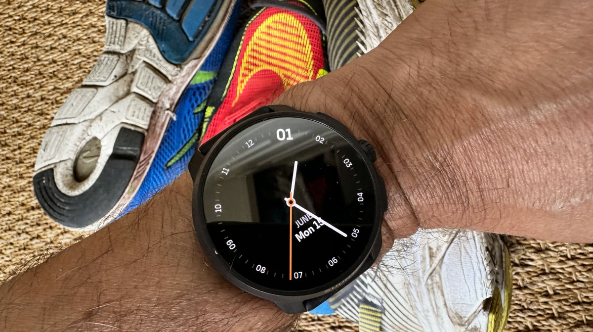 suunto Race 2 showing alternate , minimal watchface, set above the authors running shoe collection