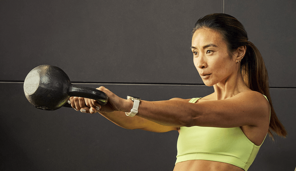 Garmin Venu 4 in use mid-workout, woman working with kettlebells