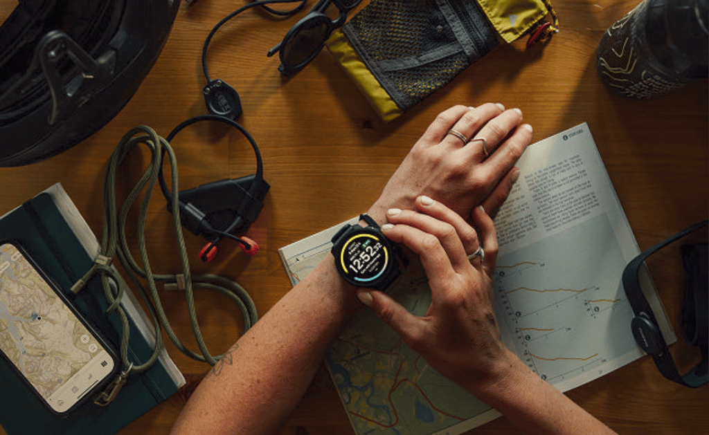woman at home planning complex outdoor ultra adventure with suunto vertical 2 routes and maps