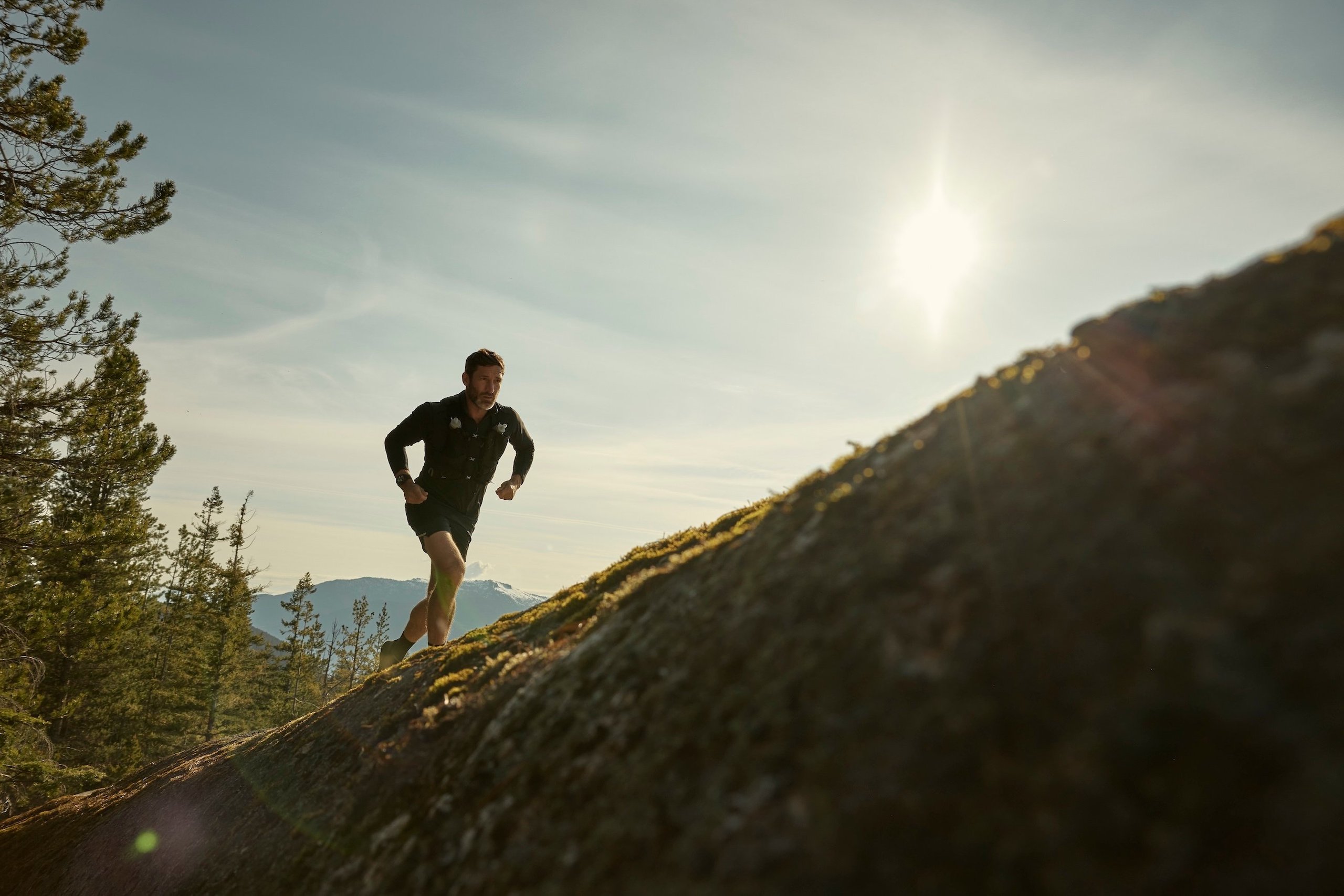 man running heading uphill with fenix watch, symbolising Garmin's sales growth in quarterly earnings call. Image credit: Garmin