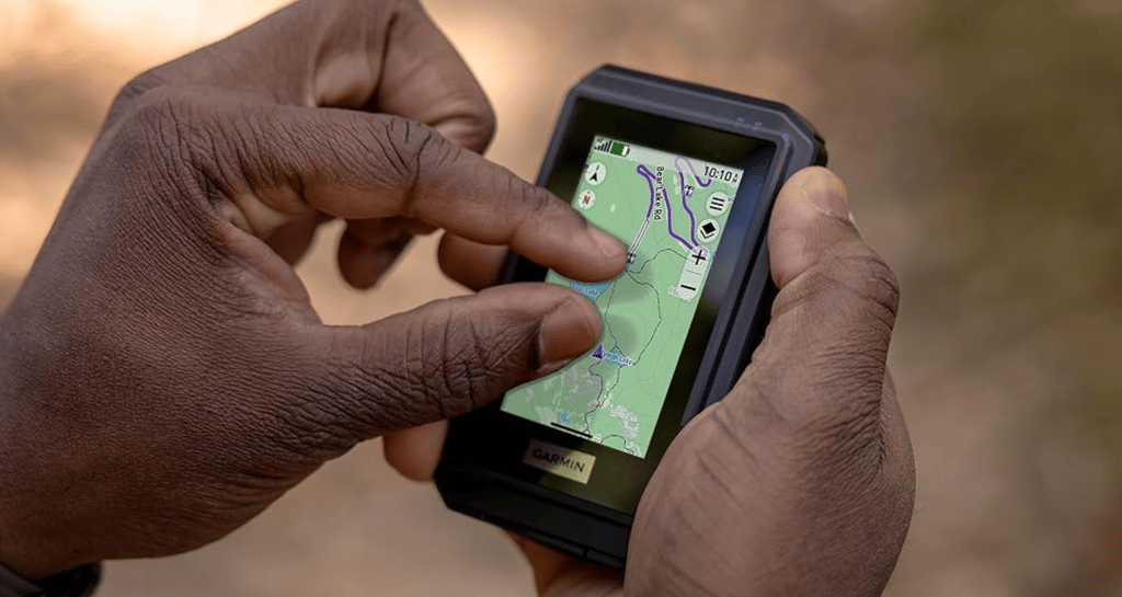 garmin etrex touch review main image showing man pinch zooming into map detail