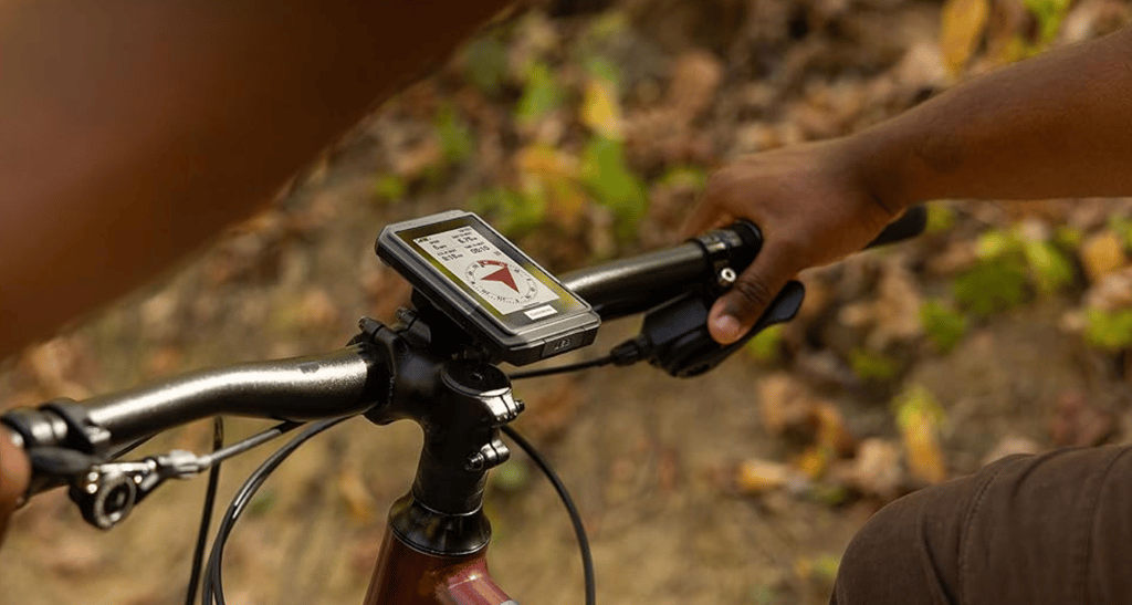 man cycling with Garmin etrex touch on handlebars showing compass heading