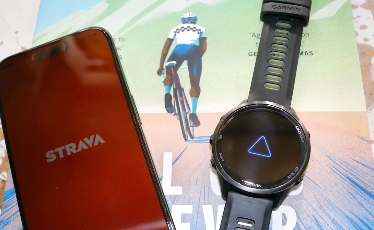 Strava on mobile app, cyclist on open road with Garmin Forerunner 970