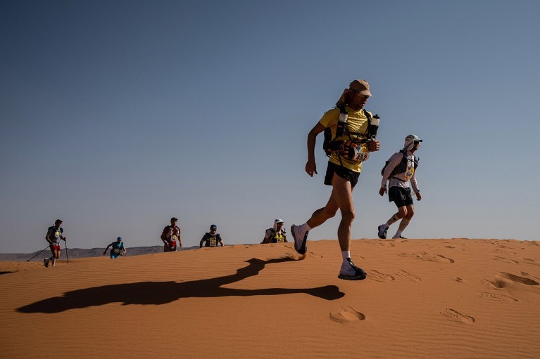 ultra runners and cyclists competing in a desert landscape