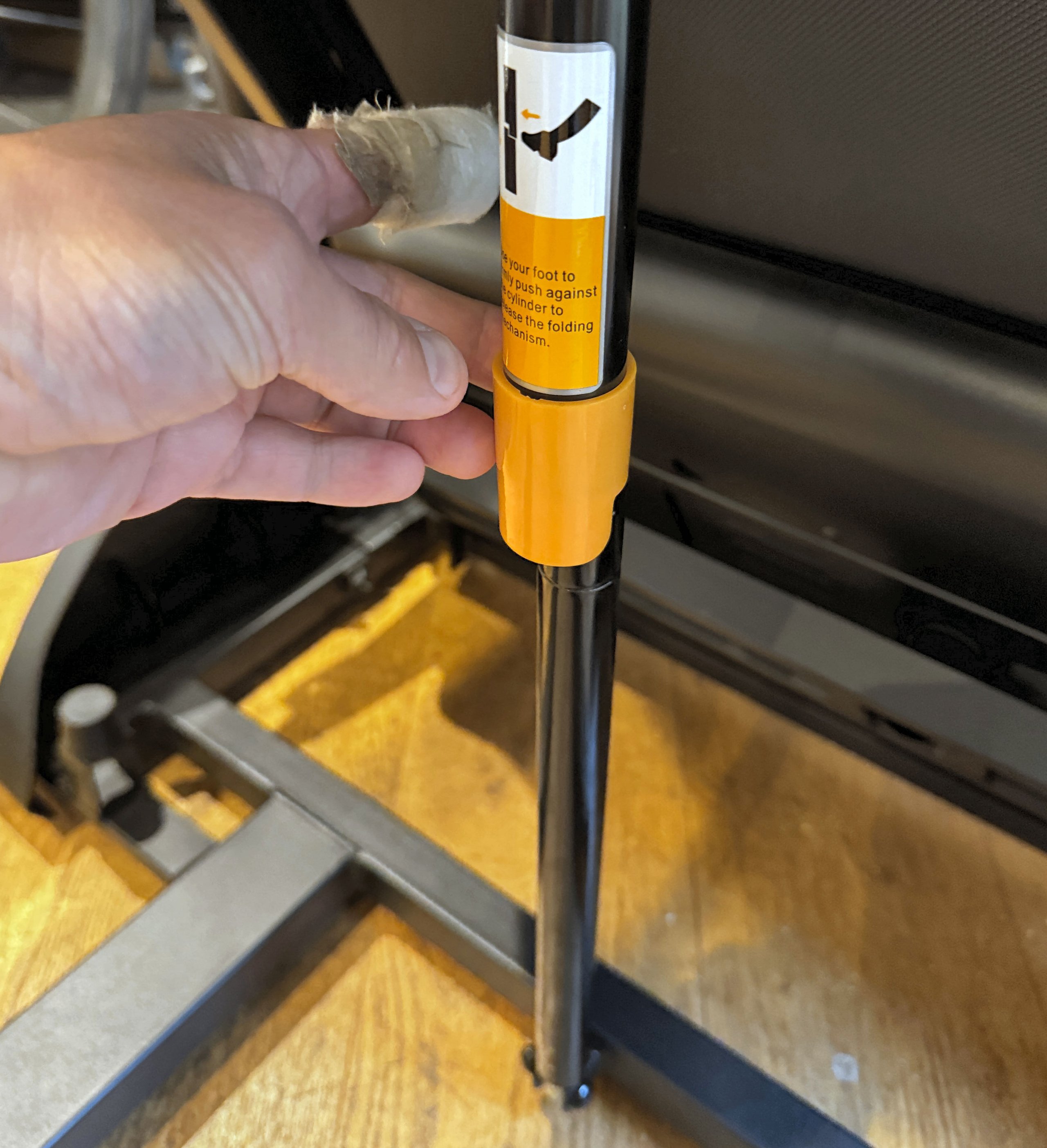 Unlocking mechanism for THERUN T15 folding treadmill storage