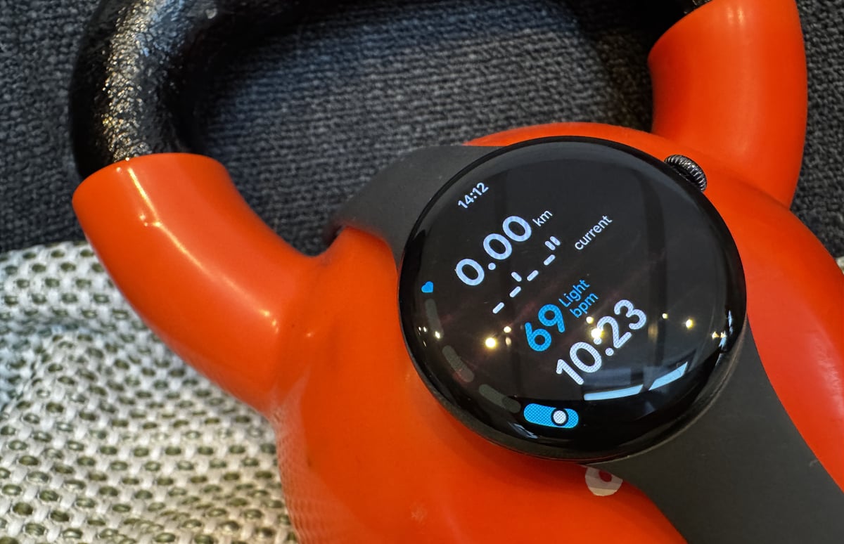 Google Pixel Watch 4 Wear OS 6.1 workout mode showing hr bpm with a kettlebell