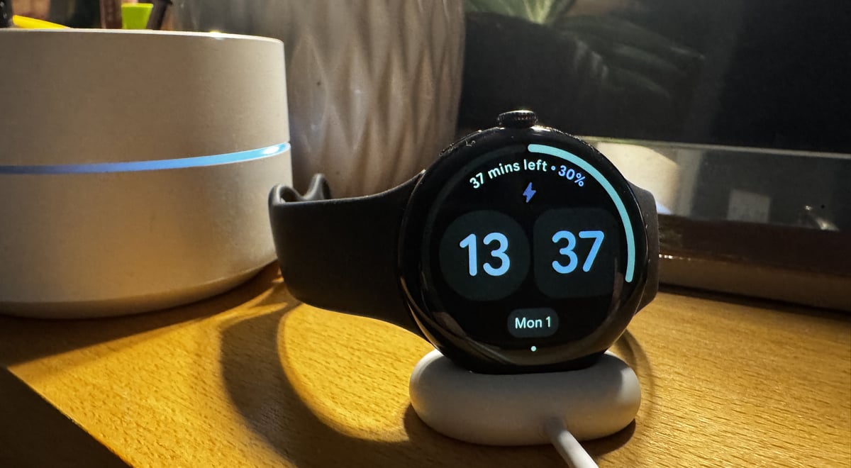 Google Pixel Watch 4 Wear OS 6.1 on fast charger showing bedside clock mode