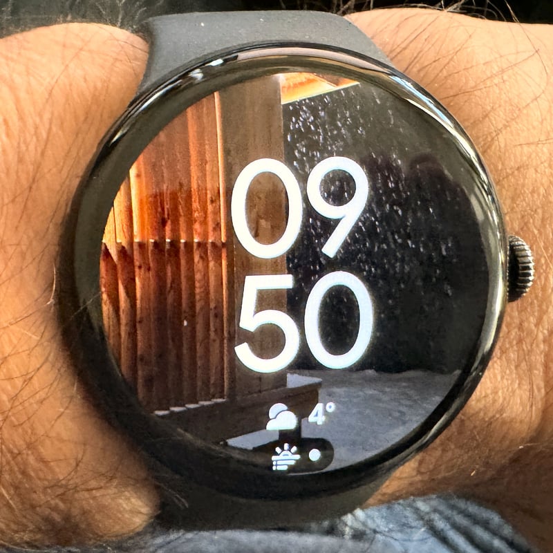 Pixel Watch 4 Photos Watch Face showing a user photo as the background