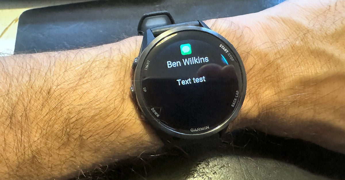 Garmin Forerunner 970 smartwatch receiving a full text message notification from an iPhone