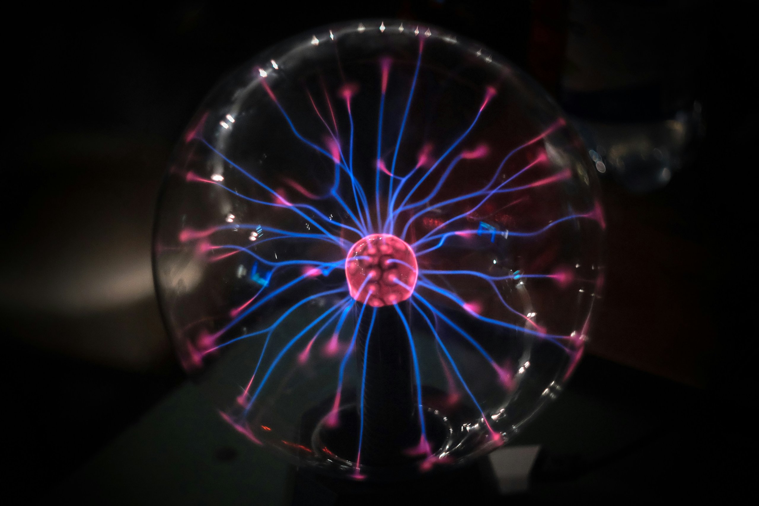 Plasma ball illustrating electricity and energy consumption in electronics, to represent the concept of electron spin and next-gen spintronics for ultra-low power wearable devices and MRAM technology.
