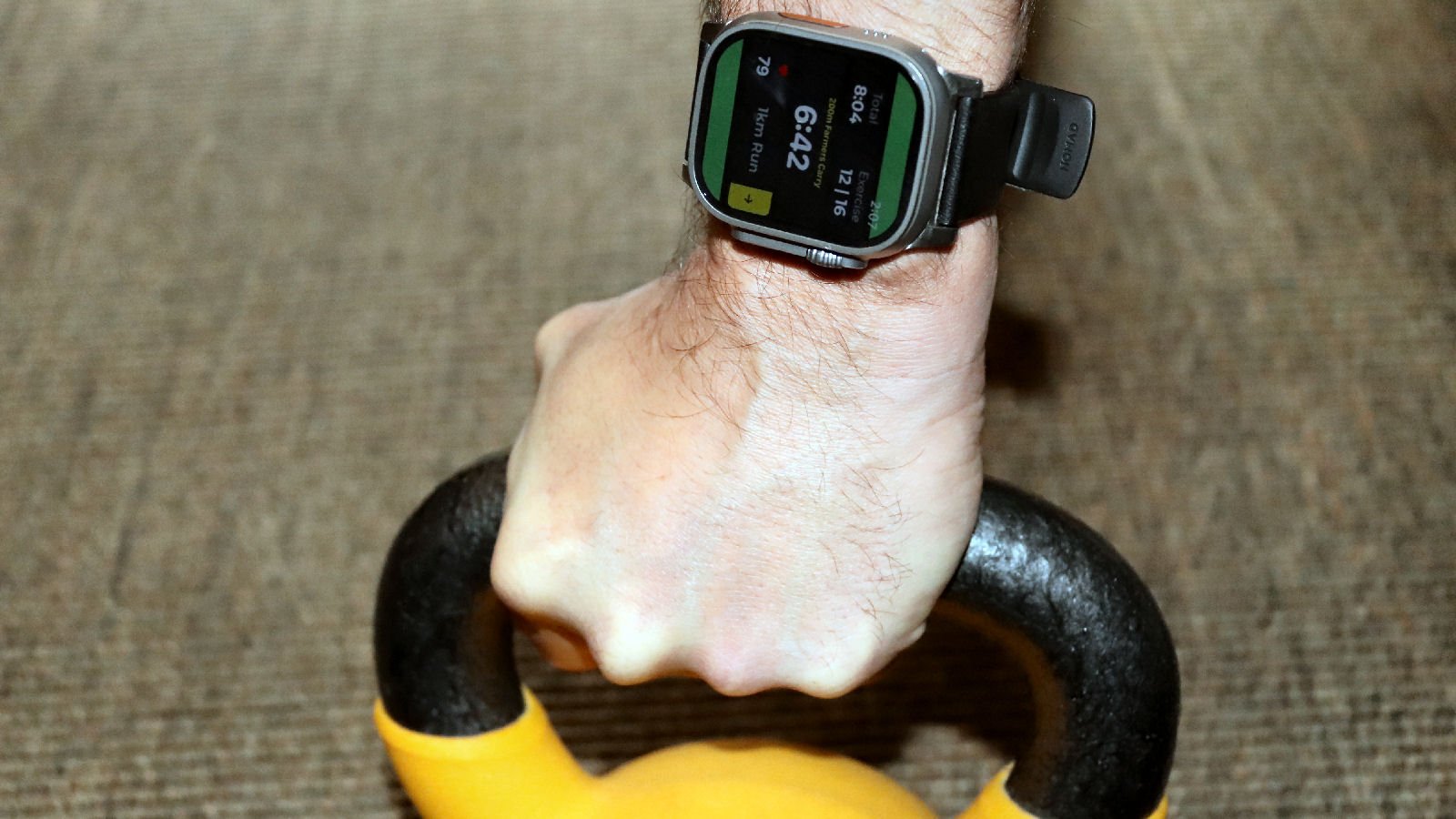 Apple Watch Ultra 3 with Roxfit app during farmers carry exercise in HYROX simulation race