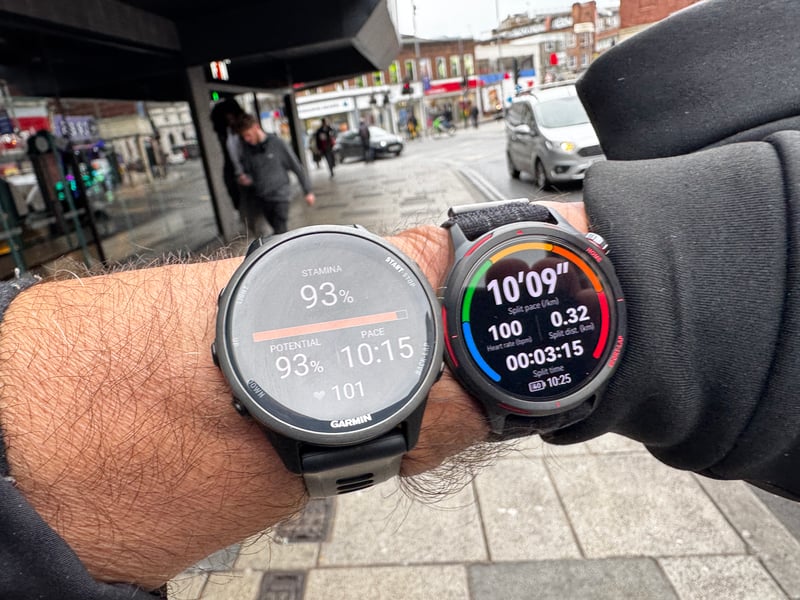 huawei watch gt runner 2 runner wearing two watches going under a shop awning in an urban area to test accuracy against forerunner 970-