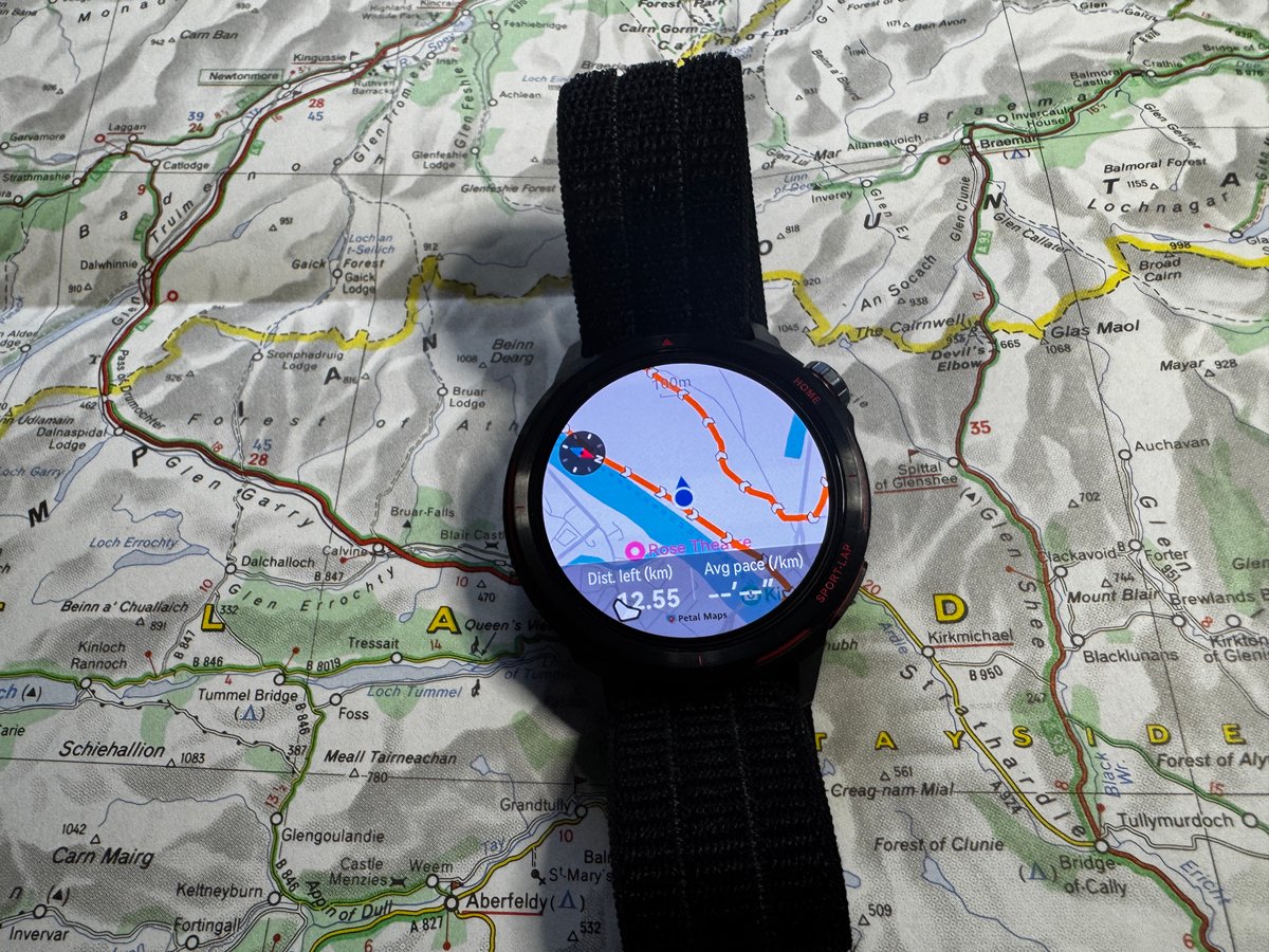 Huawei Watch GT Runner 2 displaying navigation route on AMOLED screen alongside paper map