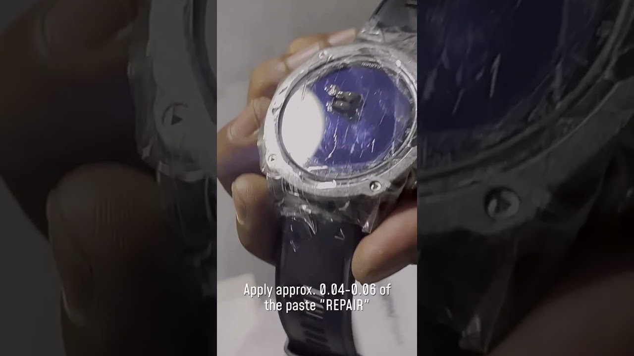 Close-up of scratched Garmin smartwatch lens showing surface damage on Gorilla Glass