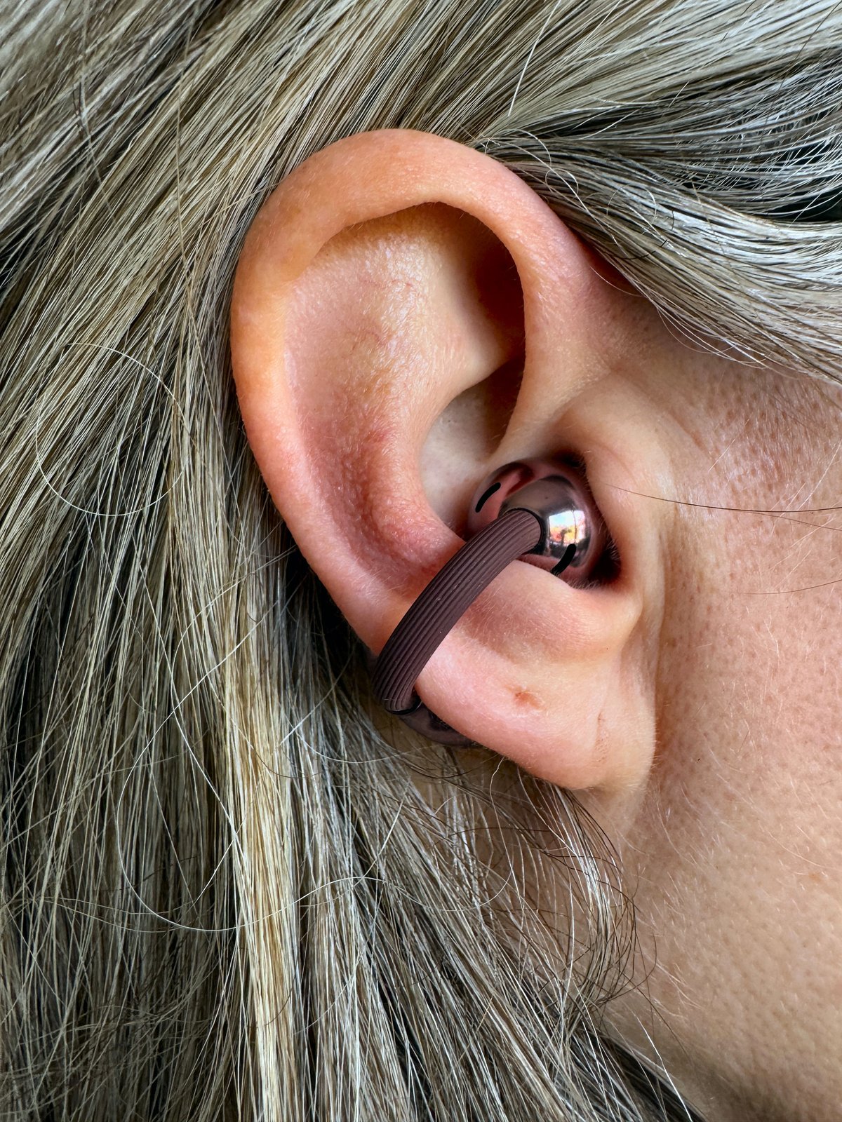 Huawei FreeClip 2 clipped around the outer ear showing the open-ear fit with nothing inside the ear canal