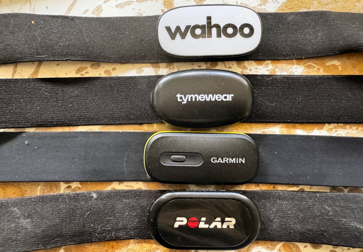 Tymewear VitalPro chest strap shown next to Polar H10, Wahoo and Garmin HRM 600 for size comparison