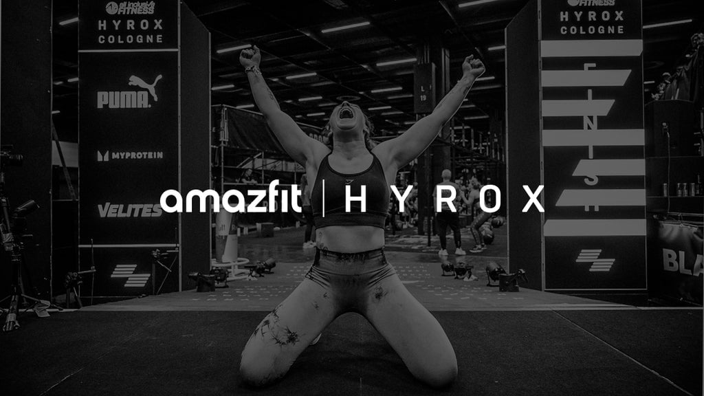 HYROX athlete arms raised in celebration crossing finish line, Amazfit official wearables partner