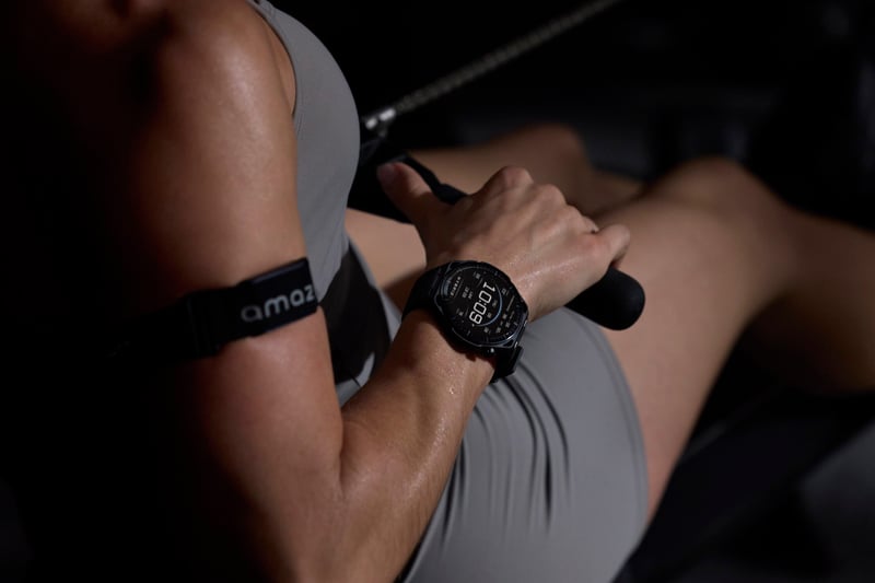 Amazfit smartwatch and Helio Strap worn by a HYROX athlete on the erg rower
