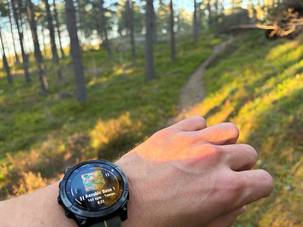 A runner outdoors with a Garmin watch, using Beatpace.