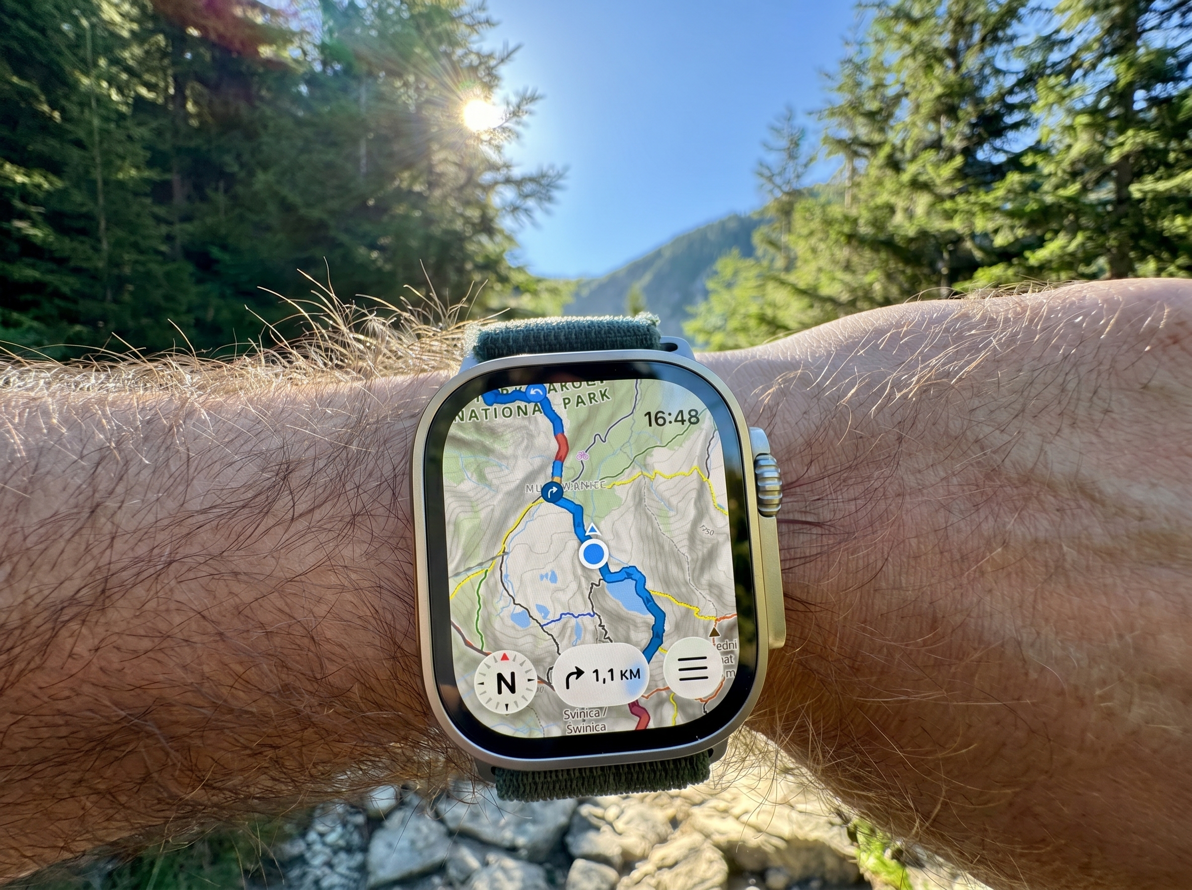 WristTopo offline topographic map on Apple Watch Ultra 3 with mountains and trees behind