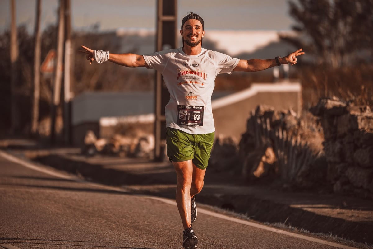Smiling runner enjoys the thrill of a marathon on a sunny day outdoors.