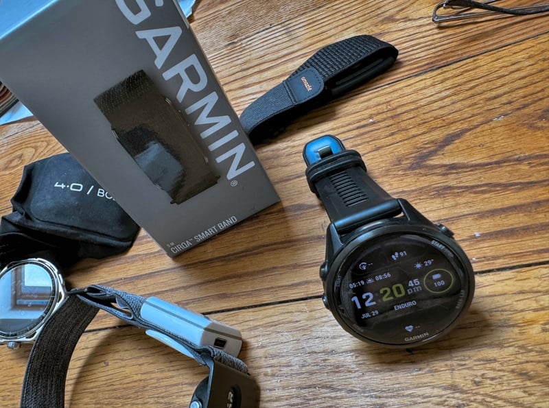 Garmin CIRQA smart band worn on upper arm bicep during sports testing, replacing Polar Sense as reference HR device
