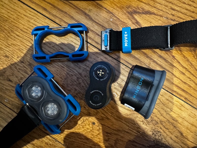 Kineon MOVE+ red light therapy components: three pods, pod holders and adjustable straps