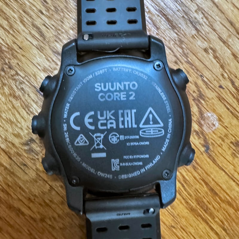 Suunto Core 2 caseback showing regulatory marks, CR3032 battery compartment and 100 metre water resistance rating