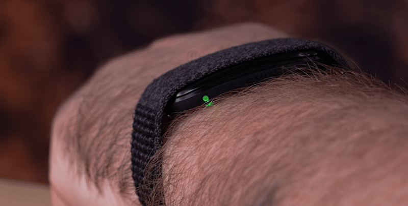 Garmin CIRQA module side view with the status LED lit green, the indicator for a full battery