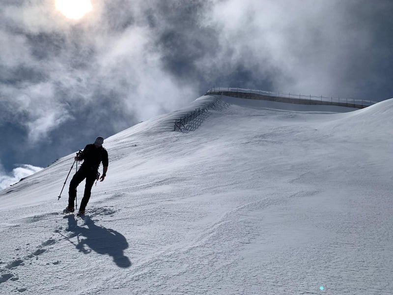 Train to Mountain co-founder Jakob Ulcnik climbing a snow slope in crampons.