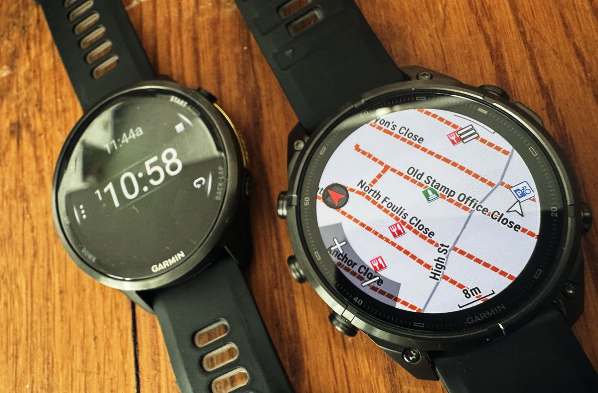 Garmin Fenix 9 Pro showing map screen with street names and Forerunner 970 with a stopwatch timer