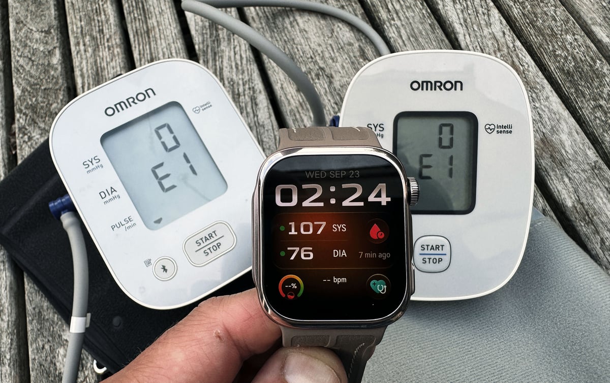 Huawei Watch D3 blood pressure watch shown next to two reference biceps-worn blood pressure monitors