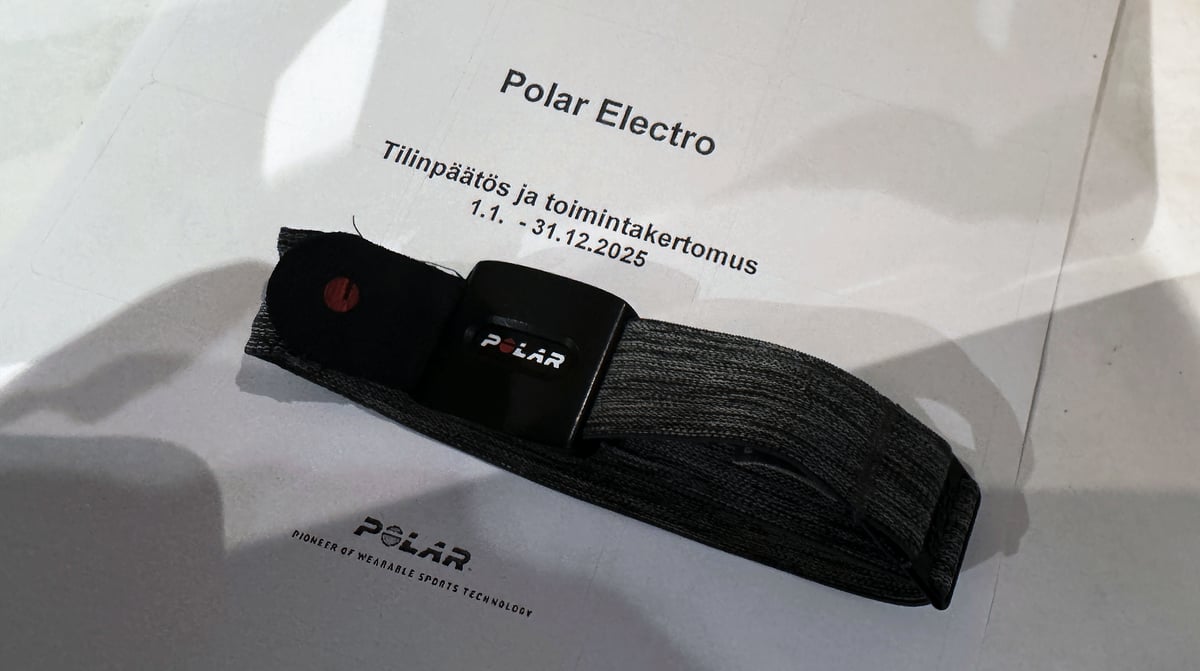 Polar Electro 2025 financial statement cover page with a Polar wearable device resting on top