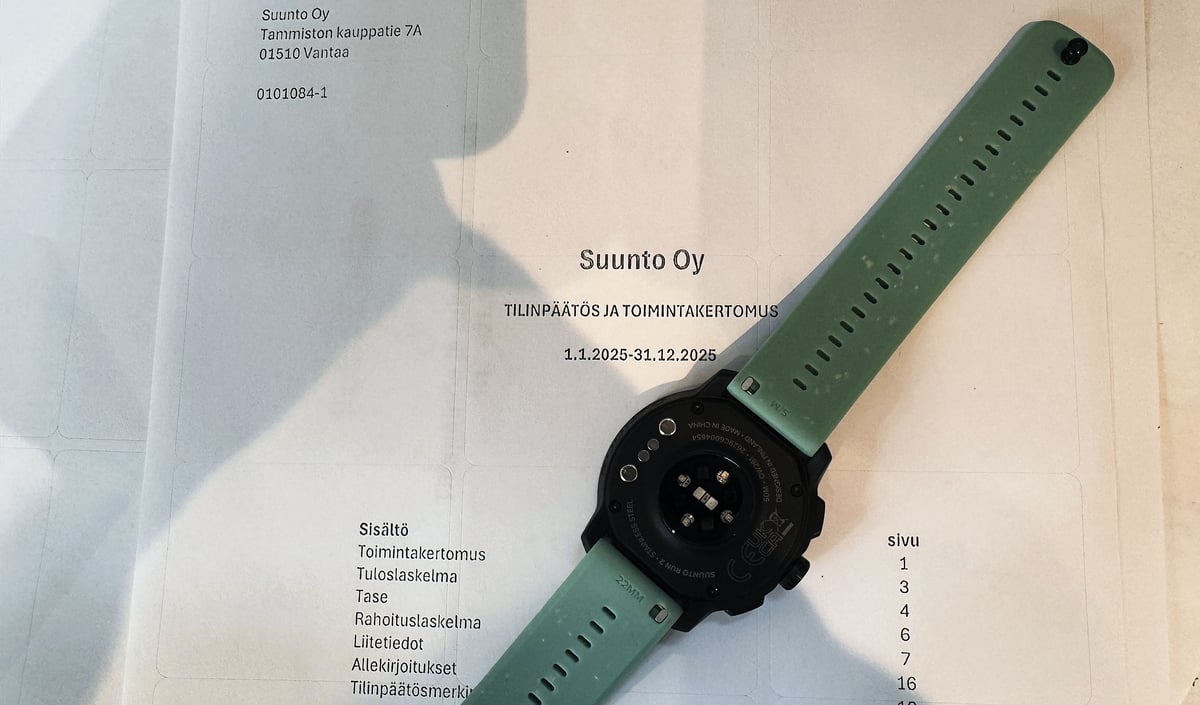 Suunto Oy 2025 financial statement cover page with a Suunto Run 2 watch resting on top