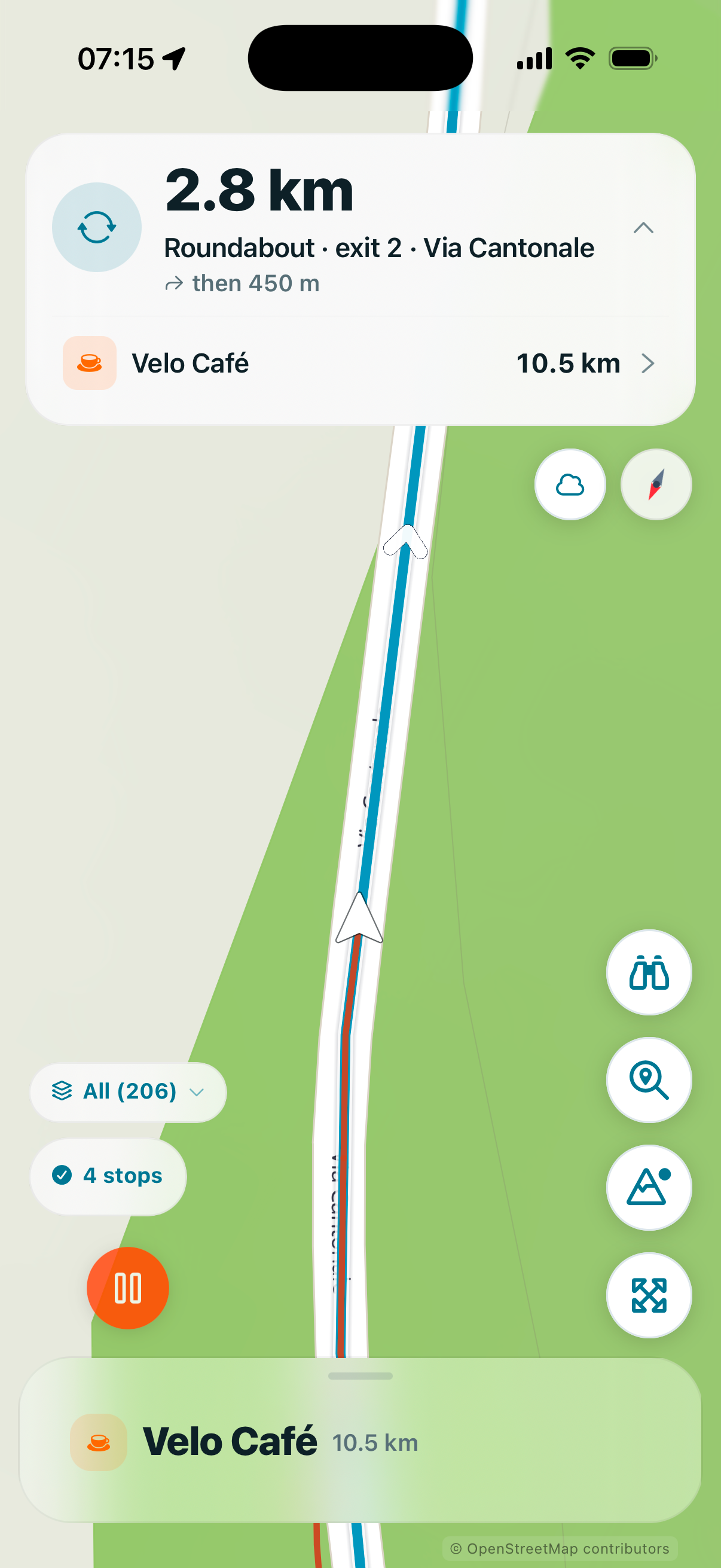 Route Companion phone navigation showing the next turn and Velo Cafe as the next marked stop with its distance