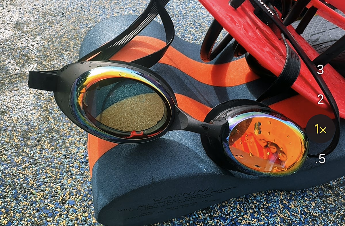 HoloSwim 3 Pro smart swim goggles poolside with a pull buoy and paddles