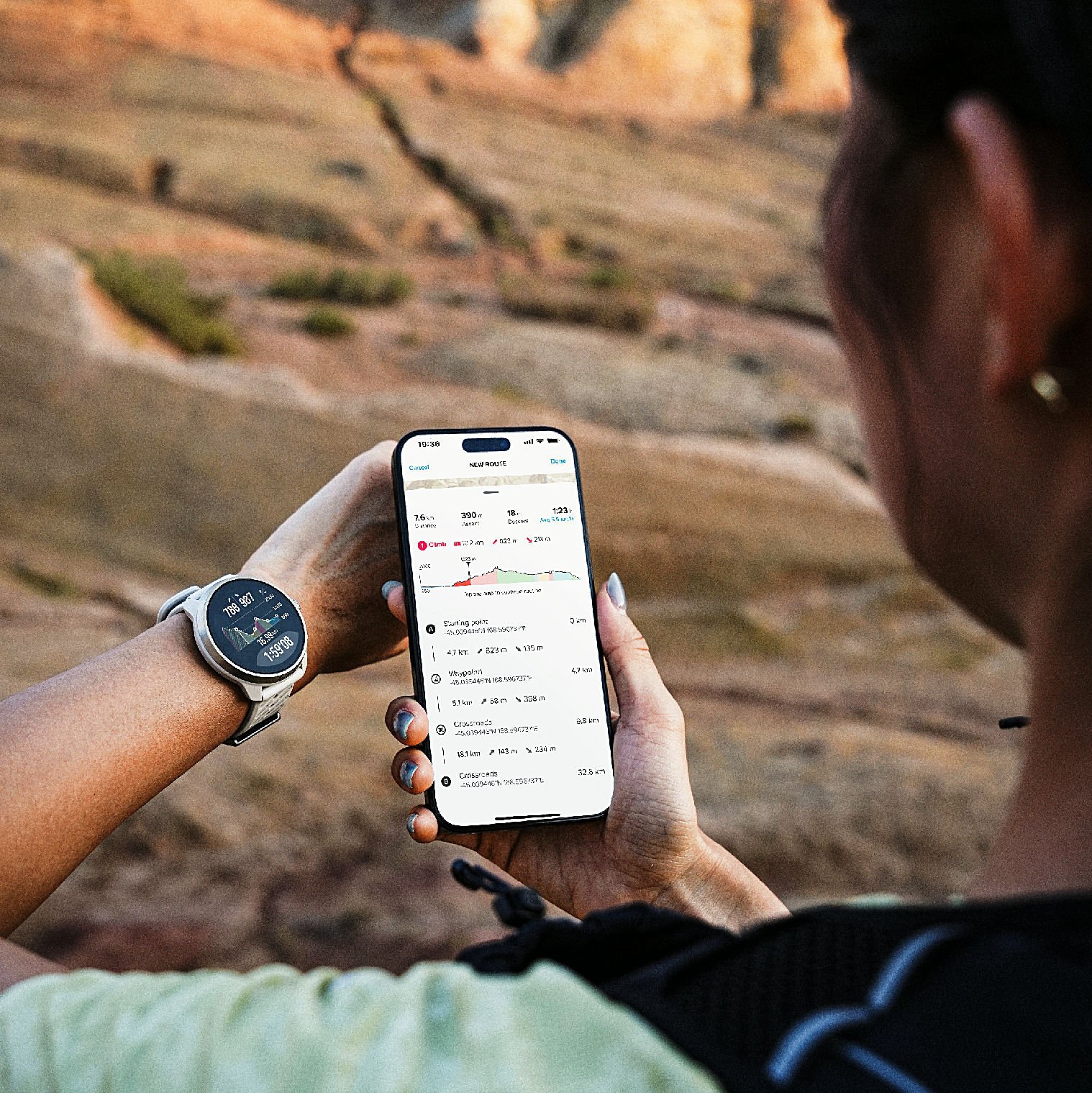 Trail runner checking a route elevation profile in the Suunto app while wearing a Suunto watch